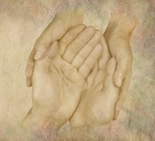 Caring for those in need website banner - female hands cupped gently around male hands on a wide rough stone effect background and copy space on left